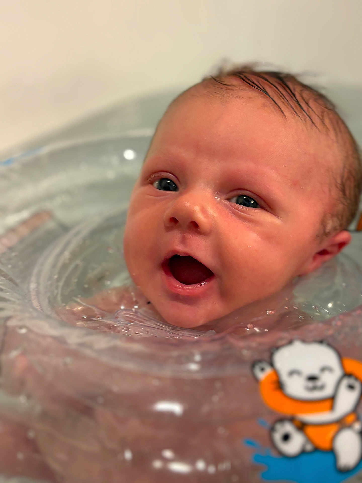 Rylan joined the competition — help win amazing prizes! baby, infant, newborn, face, eyes, mouth_open, wet_hair, water, bath, bathtub, float_ring, swimming_ring, plastic_ring, cartoon_sticker, smile, closeup, portrait, cute, wet_skin, bubbles