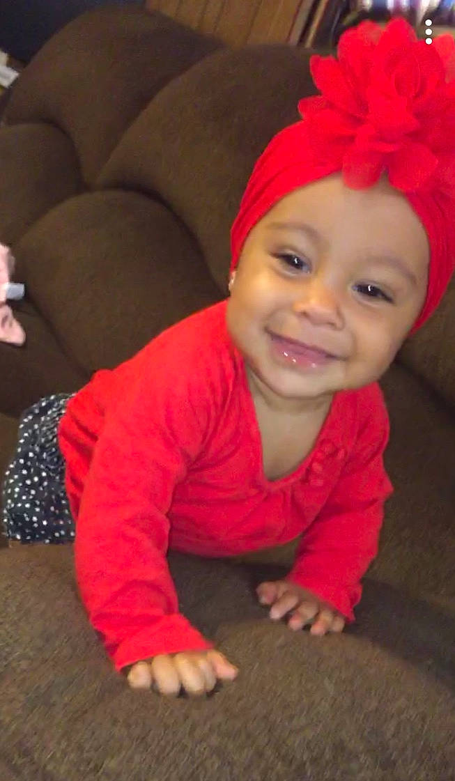 Avelyn is registered to the contest to win money with this photo: baby, cheek, child, hair_accessory, headband, headgear, headwear, joy, person, pink, red, smile, toddler