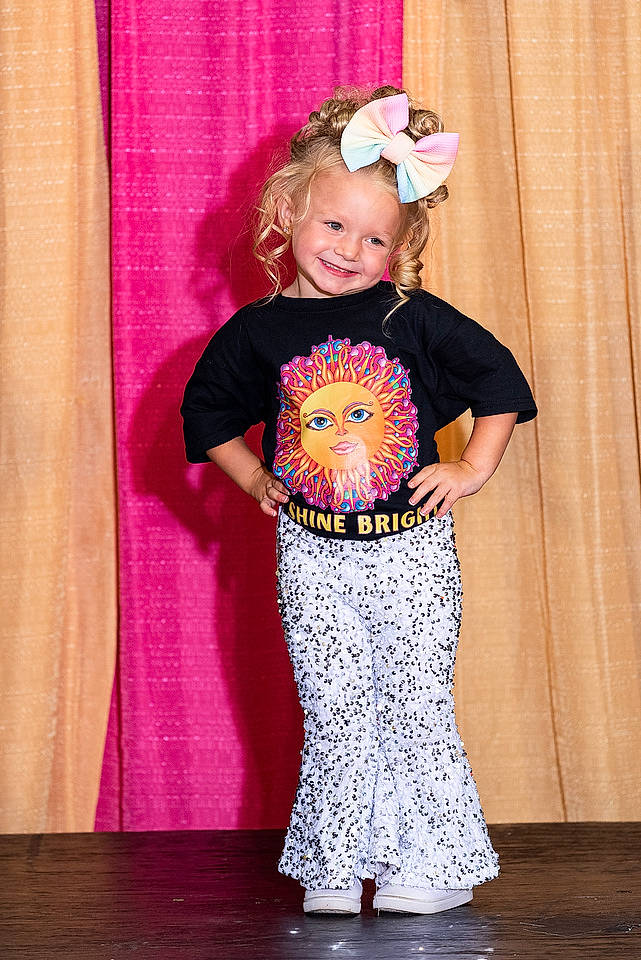 Bella Grace is registered to the contest to win money with this photo: abdomen, baby_toddler_clothing, curtain, embellishment, entertainment, event, fashion_design, fun, happy, joy, magenta, pattern, performing_arts, person, pink, sleeve, smile, sweatpant, textile, toddler