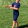 boy, child, outdoor, grass, sidewalk, toy, play, summer, casual_clothing, shorts, tshirt, sneakers, active, sunlight, fun, greenery, young, person, happy, recreation