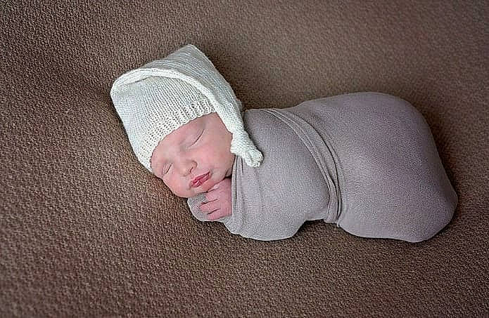 Denver joined the competition — help win amazing prizes! baby, baby_sleeping, baby_toddler_clothing, child, comfort, face, fashion_accessory, flooring, gesture, grey, head, headwear, human_body, human_leg, linens, person, sleeve, textile, thumb, toddler
