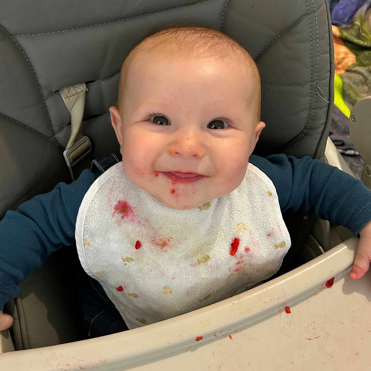 Talia participe au concours pour gagner de l'argent avec cette photo : baby, babylaughing, bib, chair, clothing, coat, cushion, cutlery, face, furniture, happy, head, homedecor, jacket, laughing, person, photography, portrait, smile, spoon