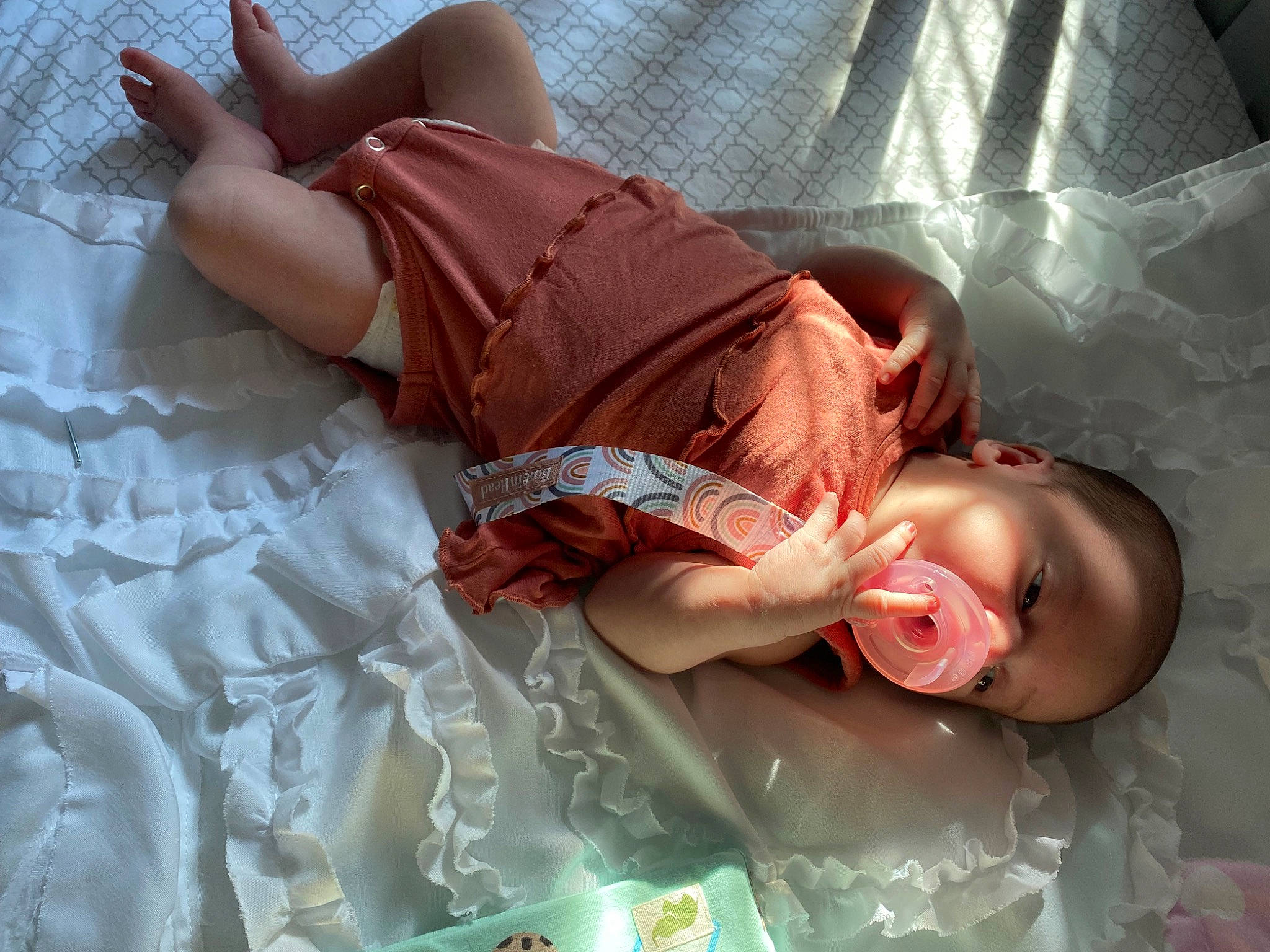 Sadie is registered to the contest to win money with this photo: abdomen, baby, baby_products, baby_toddler_clothing, chest, child, comfort, flash_photography, flesh, human_body, human_leg, knee, linens, mouth, pattern, peach, person, room, skin, thigh