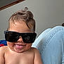 toddler, child, sunglasses, tongue_out, shirtless, smile, hair, indoor, legs, jeans, light_background, cute, happy, person, portrait, skin, playful, funny_expression, casual, young_child
