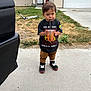 Duck joined the competition — help win amazing prizes! toddler, child, standing, drink, straw, shirt, sneakers, concrete, grass, house, driveway, sidewalk, outdoor, casual_clothing, expression, person, footwear, plant, curious, daytime