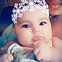 Zada is registered to the contest to win money with this photo: baby, infant, adult, smile, filter, snowflake_crown, sparkles, blanket, hand, face, eyes, eyelashes, lips, cheek, pacifier, portrait, indoor, soft_light, cozy, caregiver