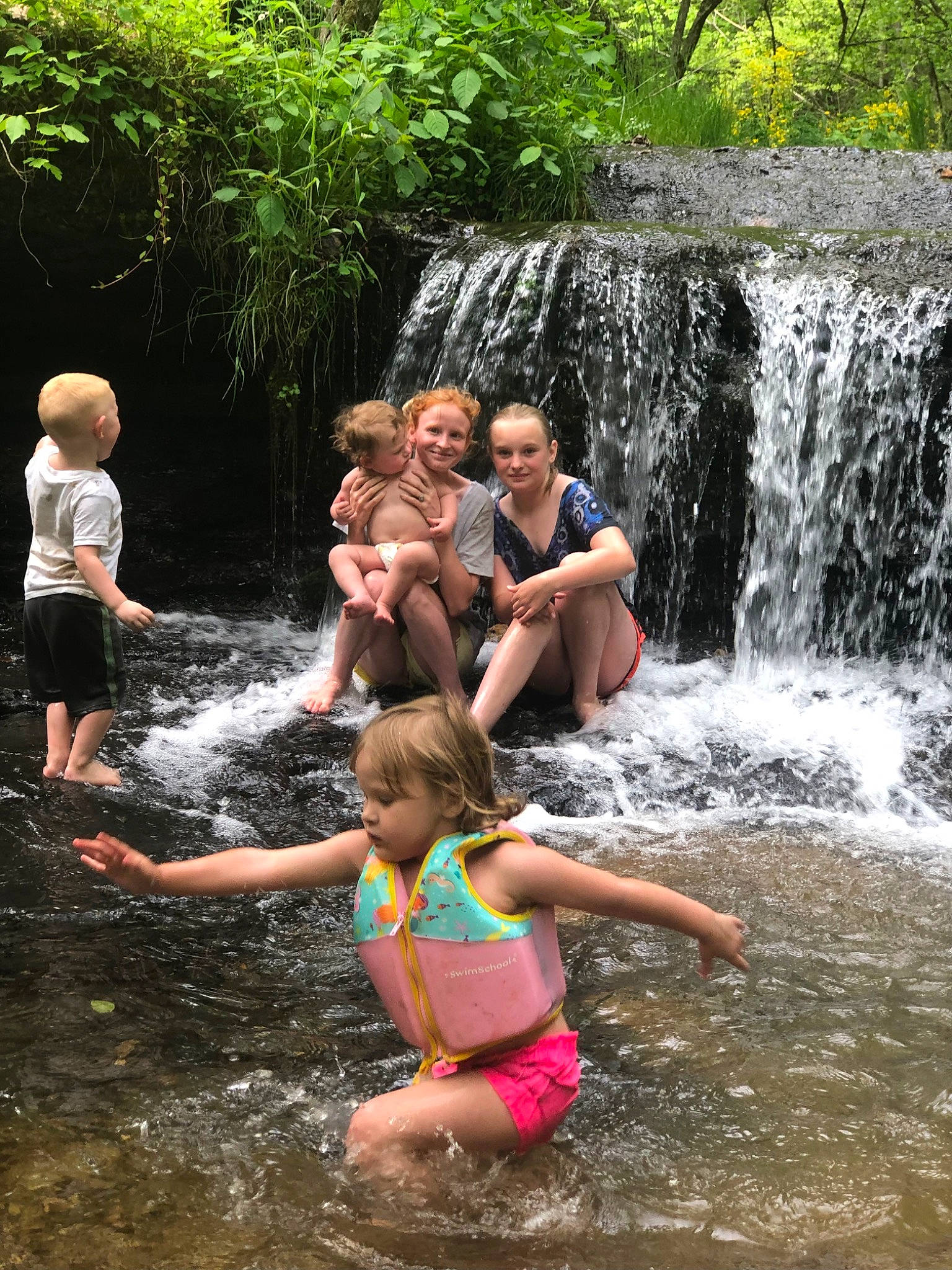 Arianna is registered to the contest to win money with this photo: fluvial_landforms_of_streams, fun, happy, joy, leisure, mammal, natural_landscape, person, plant, recreation, shorts, spring, stream, summer, swimwear, toddler, tree, water, water_feature, water_resources