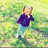 Lyana a rejoint le concours — aidez-le/la à gagner de superbes lots ! child, girl, grass, pigtails, dandelion, outdoor, nature, flower, standing, casual_clothing, blue_pants, jacket, white_shoes, sunlight, greenery, playing, cute, portrait, sparkles, purple_border