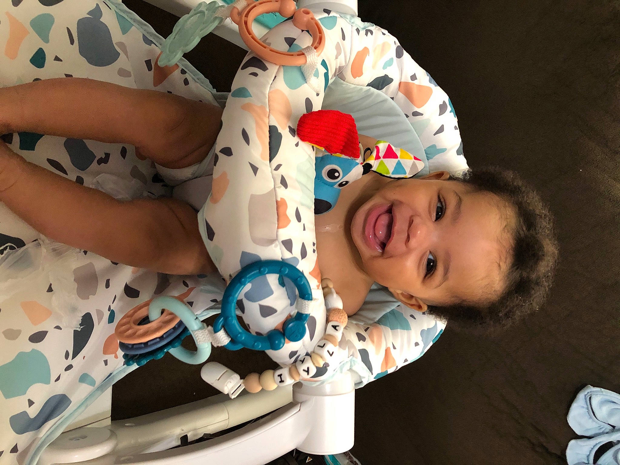 Iyla is registered to the contest to win money with this photo: arm, baby, baby_products, baby_toddler_clothing, child, event, eye, fashion_accessory, fun, happy, hat, headgear, mouth, organ, person, product, skin, sleeve, smile, toddler