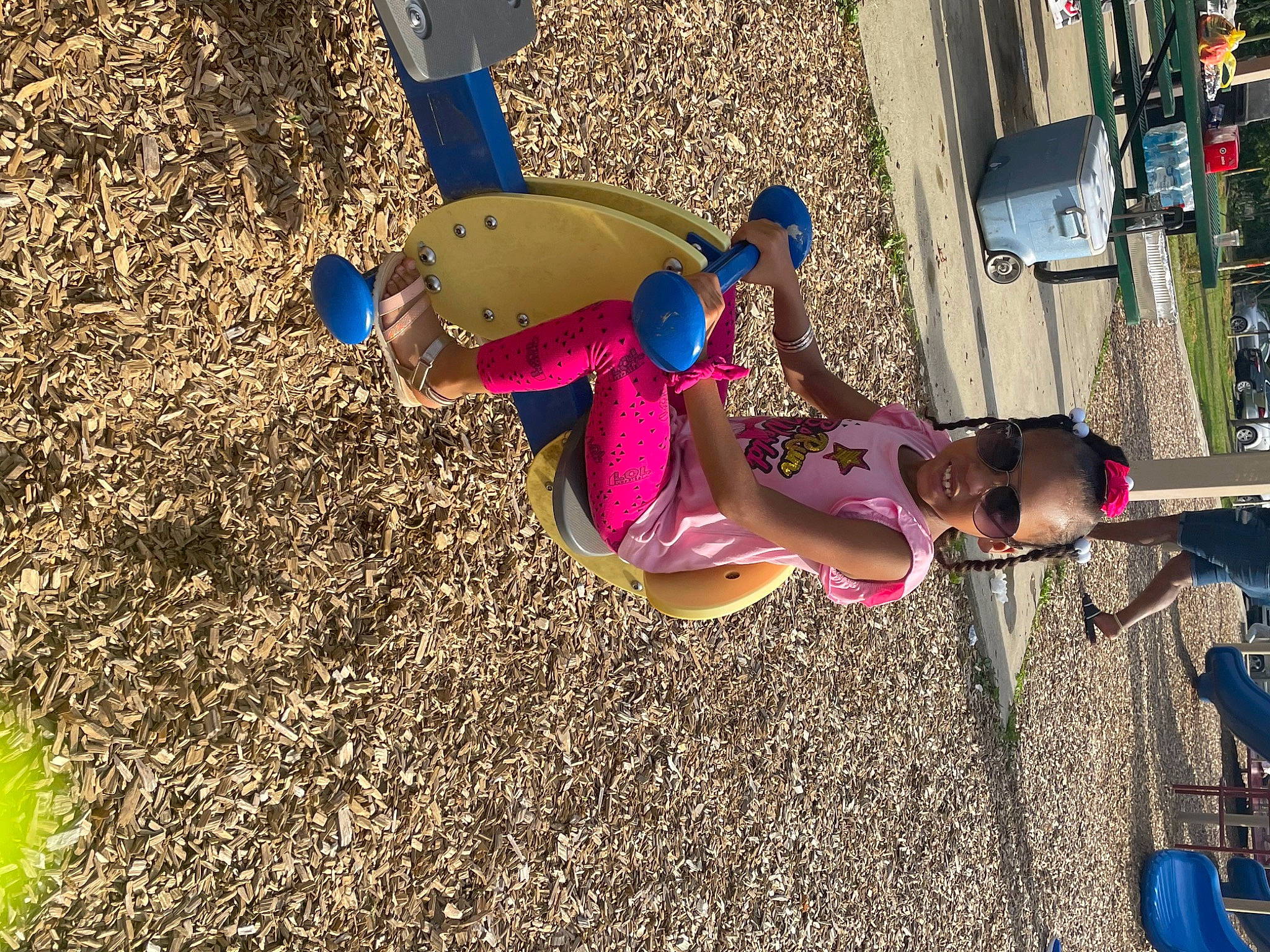 Kimora is registered to the contest to win money with this photo: automotive_exterior, blue, car, child, city, electric_blue, fun, grass, joy, leisure, magenta, outdoor_play_equipment, person, recreation, shadow, shorts, soil, tire, toddler, tree