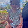 toddler, child, outdoor, sky, tree, grass, person, hand, fence, nails, blue_clothing, baby, legs, face, sitting, daylight, nature, holding, curly_hair, portrait