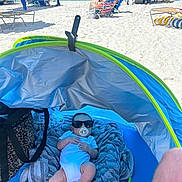 Sutton joined the competition — help win amazing prizes! baby, sunglasses, pacifier, beach, tent, blanket, ocean, sand, people, sunshine, relaxation, vacation, summer, shade, bag, blue, green, casual, outdoor, holiday