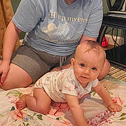 Haisley Grace joined the competition — help win amazing prizes! baby, infant, adult, person, crawling, sitting, smiling, portrait, indoor, bedroom, blanket, floral, family, parent, face, eyes, clothing, keyboard, furniture, home