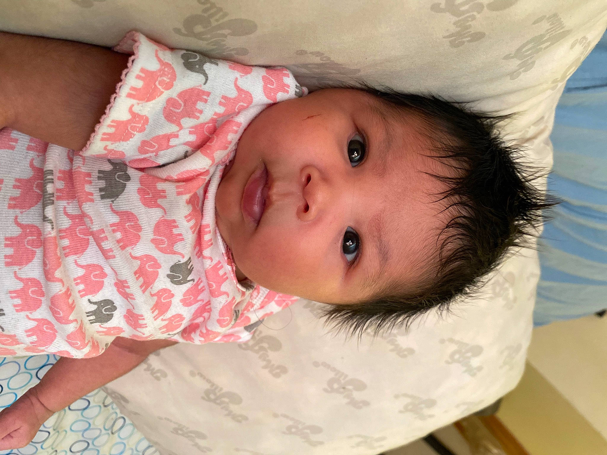 Denali is registered to the contest to win money with this photo: baby, baby_toddler_clothing, cheek, child, comfort, dress, eye, eyelash, facial_expression, happy, hat, iris, linens, lip, mouth, neck, nose, pattern, person, skin