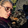 Olympe a rejoint le concours — aidez-le/la à gagner de superbes lots ! affection, black_dog, brown_markings, candid, casual, closeup, dog, face, glasses, grass, happy, holding, nature, outdoor, pet, playing, portrait, sunlight, trees, woman
