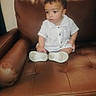toddler, child, white_clothing, button_up, leather_chair, brown_chair, indoor, furniture, sitting, curious, looking_away, short_hair, small_shoes, casual, portrait, one_person, young_child, home_interior, cute, baby