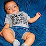 baby, boy, infant, child, tshirt, denim_shorts, blue_blanket, socks, casual_clothing, portrait, indoors, cute, relaxed, skin, face, legs, hand, laying_down, expression, young_child