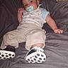 baby, blanket, casual, child, clothing, comfort, cute, footwear, gray, indoor, infant, pacifier, pants, person, polka_dot, reclining, resting, shirt, shoes, young_child