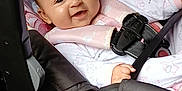 Maura joined the competition — help win amazing prizes! baby, car_seat, child, smiling, harness, plush_toy, seat_belt, infant, cute, car_interior, child_safety, pink, clothing, toy, happy, portrait, seat, person, young_child, baby_clothes