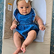 Isabella joined the competition — help win amazing prizes! baby, infant, denim_dress, headband, bow, baby_seat, cushion, barefoot, curious, cute, skin, hands, legs, indoor, portrait, child, young, person, comfortable, relaxed