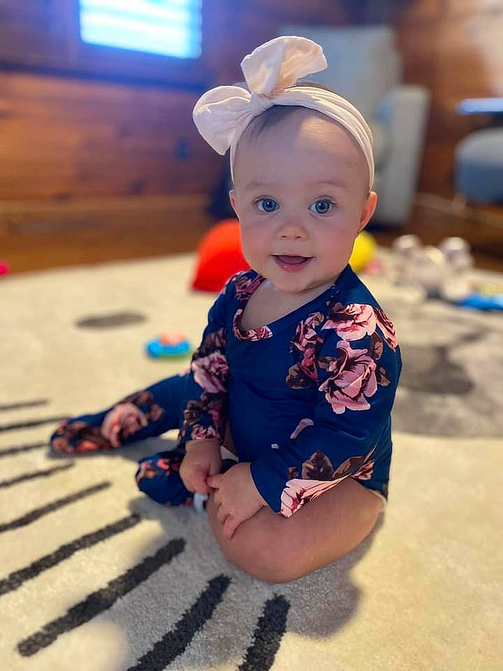 Bristol is registered to the contest to win money with this photo: baby, baby_toddler_clothing, chair, child, electric_blue, facial_expression, fashion_accessory, flooring, fun, happy, hat, headgear, human_leg, iris, pattern, person, sitting, skin, sleeve, smile