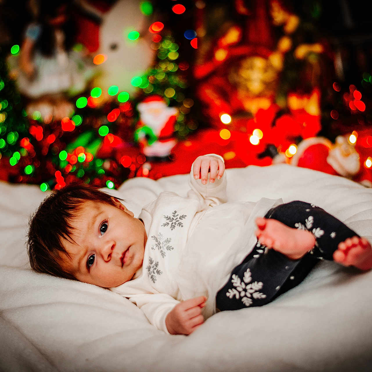 Annalee joined the competition — help win amazing prizes! baby, blanket, blurred_background, christmas_lights, clothing, colorful, cozy, cute, decorations, face, festive, holiday, indoors, infant, lying_down, person, snowflake_pattern, soft, warm, winter