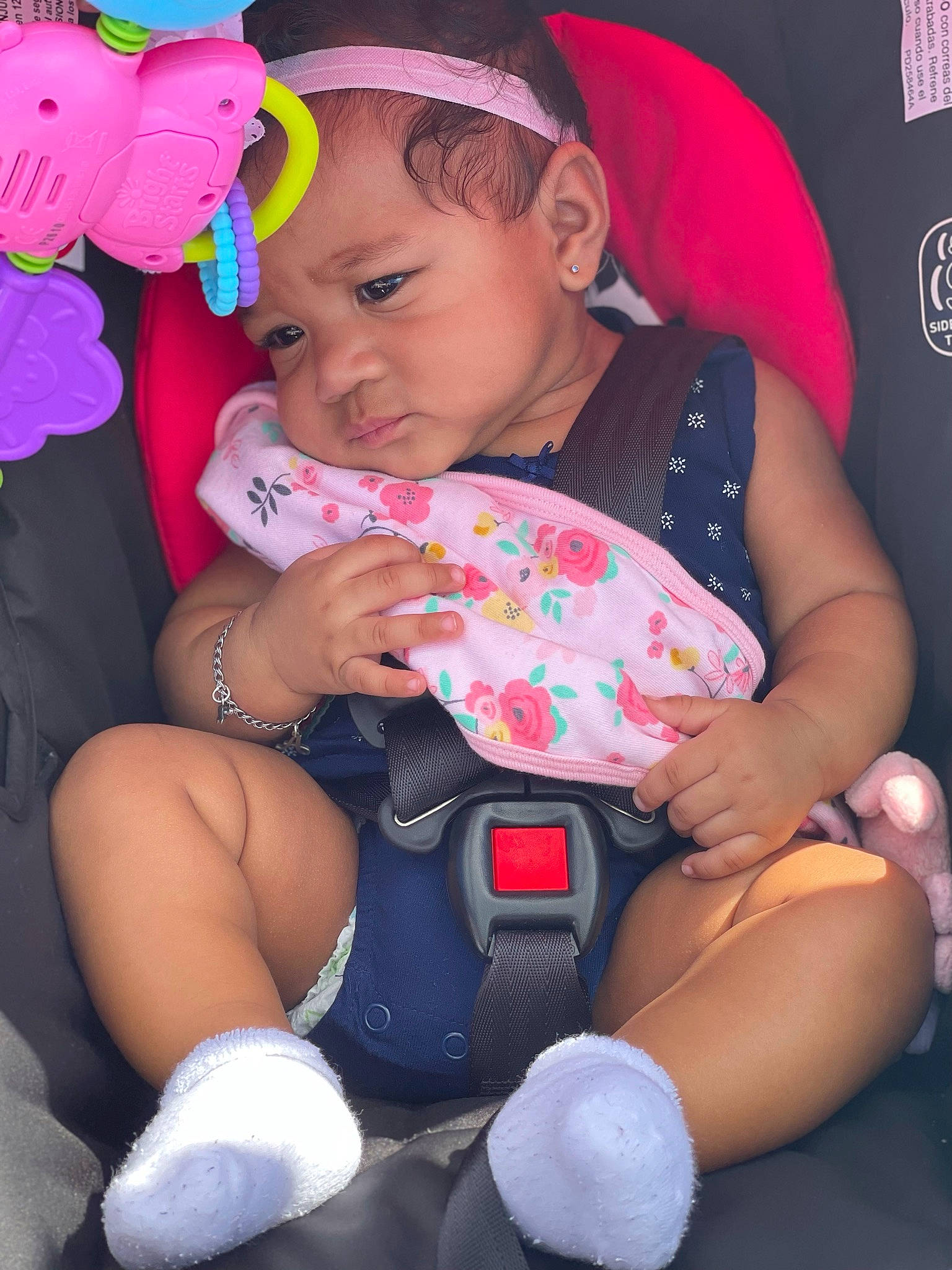 Aayah is registered to the contest to win money with this photo: arm, baby, baby_toddler_clothing, black, child, facial_expression, finger, hand, happy, headwear, human, human_body, interaction, lap, leg, organ, person, pink, purple, skin