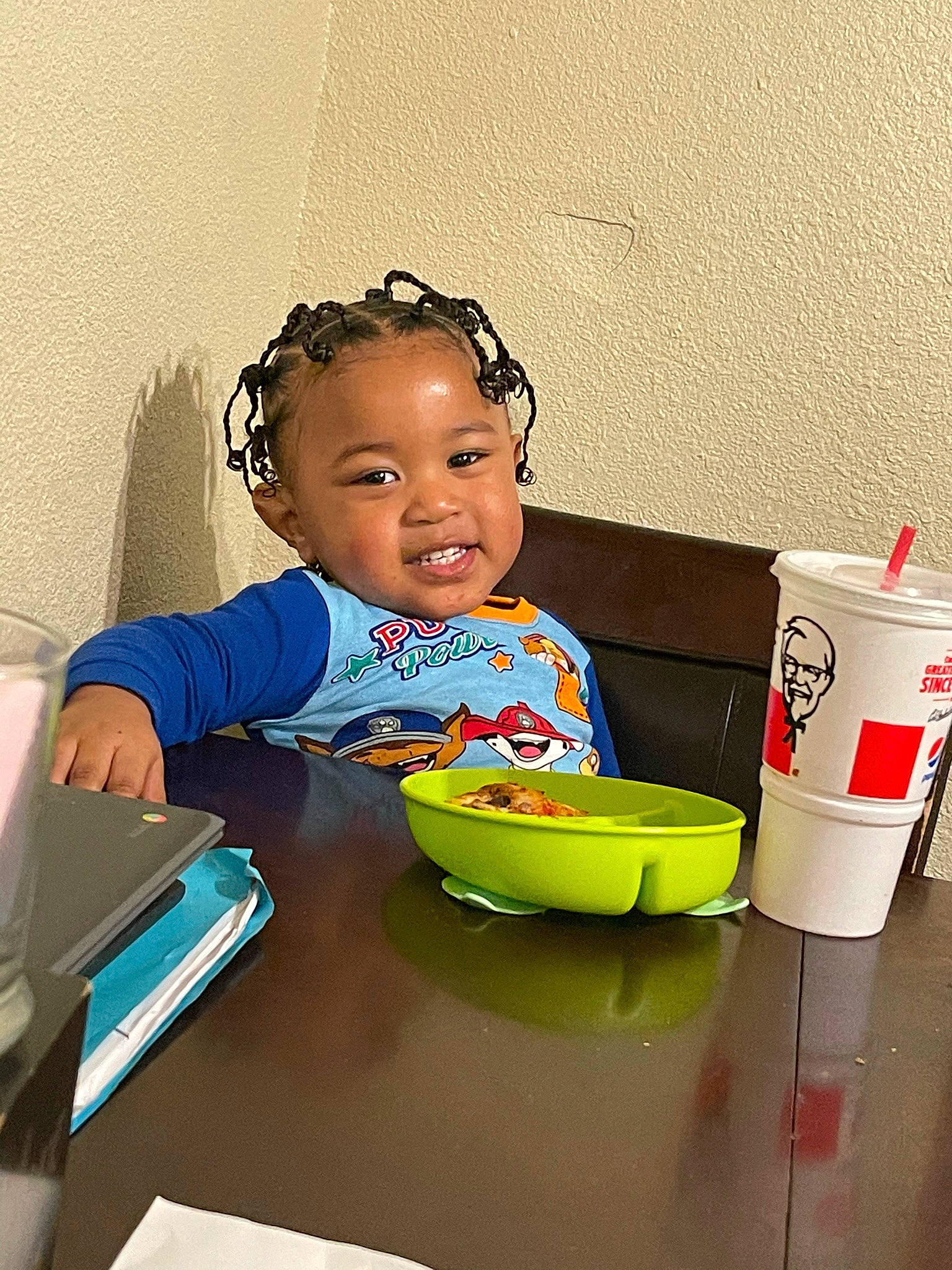 Aayan is registered to the contest to win money with this photo: baby, book, bowl, child, comfort_food, desk, drinkware, face, fun, hairstyle, office_equipment, office_supplies, person, plate, play, room, sitting, smile, table, tableware