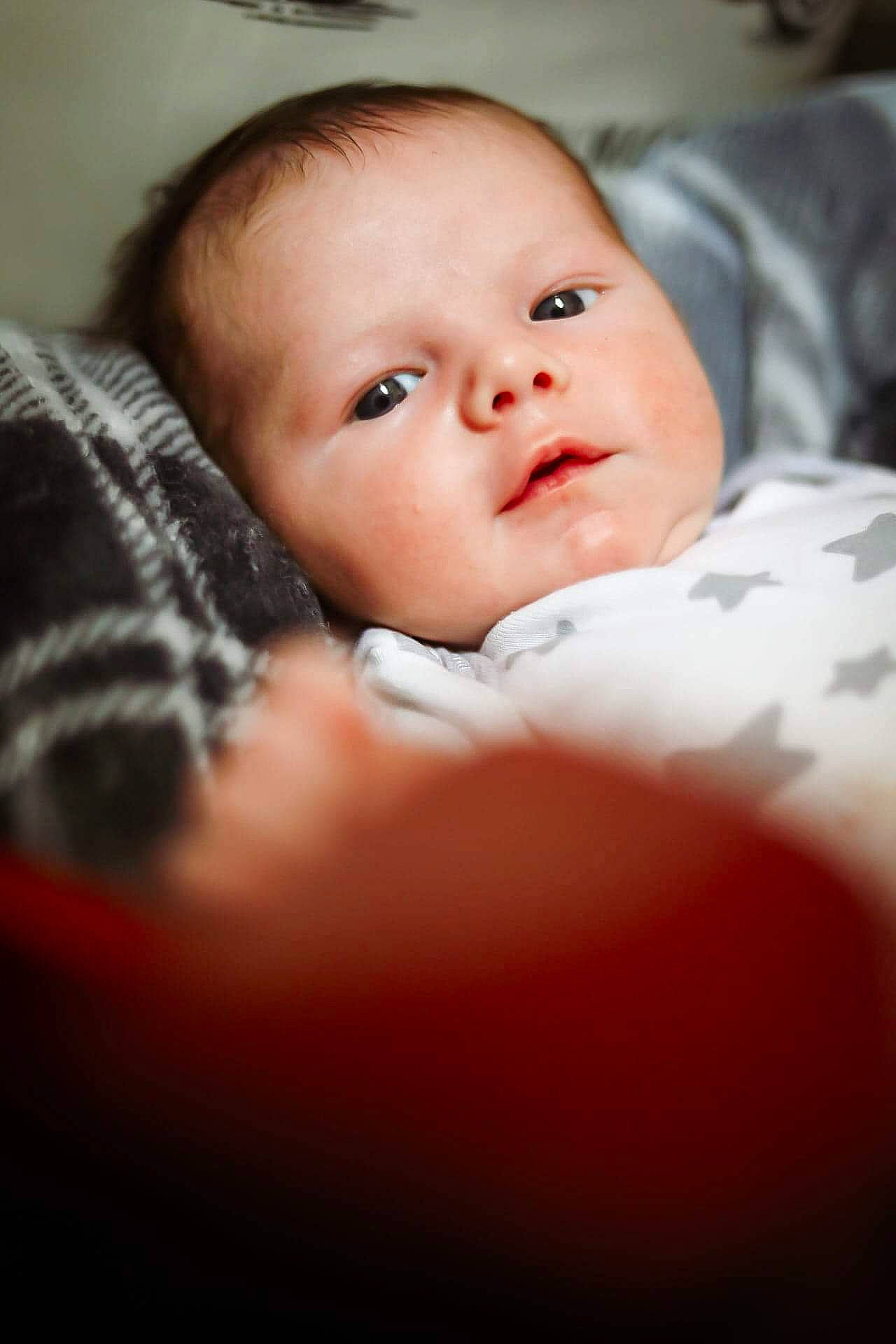 Carsyn is registered to the contest to win money with this photo: baby, baby_toddler_clothing, cheek, child, chin, comfort, eyebrow, eyelash, finger, flash_photography, iris, linens, lip, mouth, nose, person, portrait_photography, room, sitting, skin