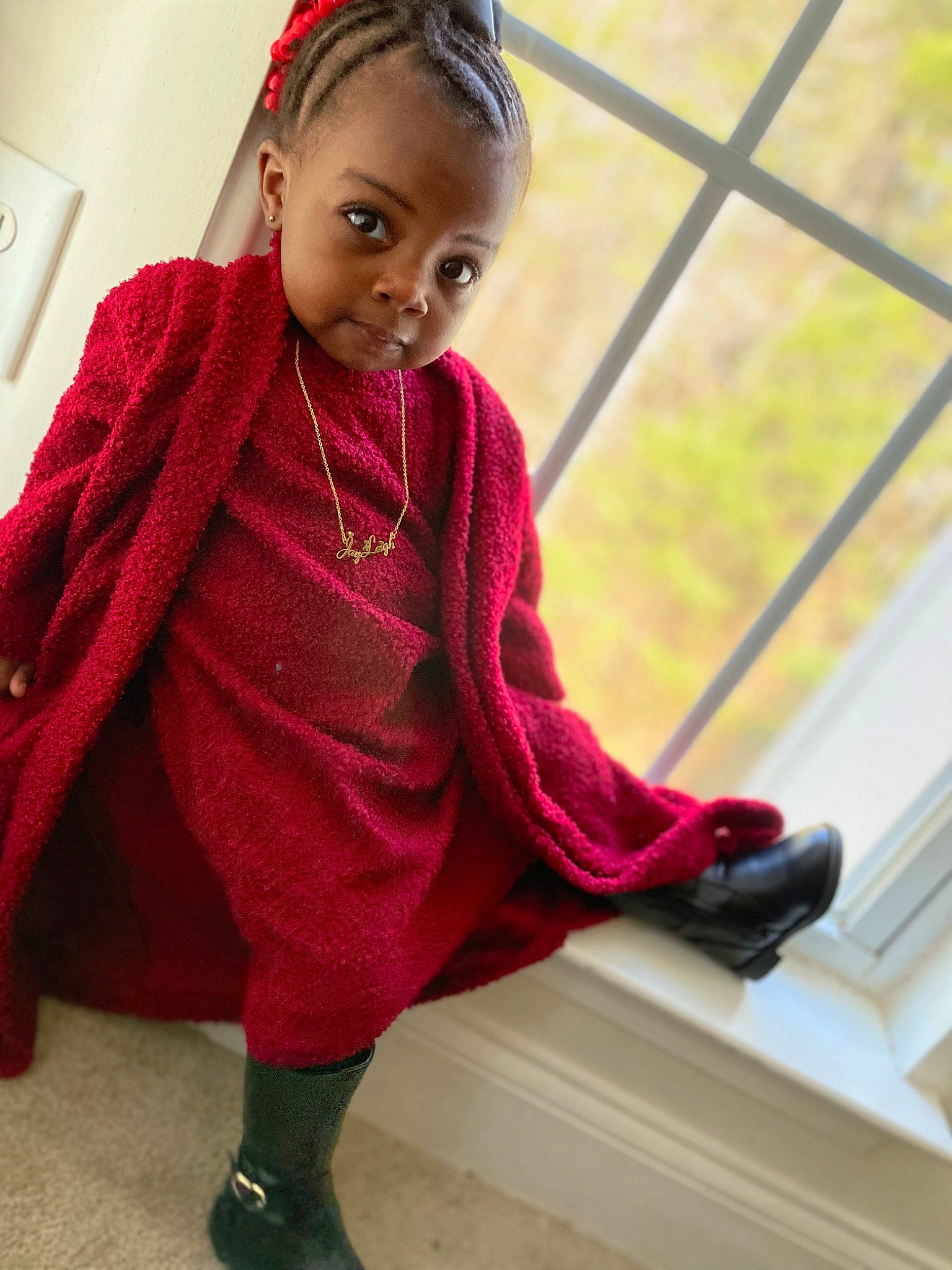 Jay'Leigh is registered to the contest to win money with this photo: baby, baby_toddler_clothing, child, dress, face, fashion_accessory, flooring, foot, hair, head, human_leg, jewellery, magenta, pattern, person, red, sandal, skin, sleeve, sock