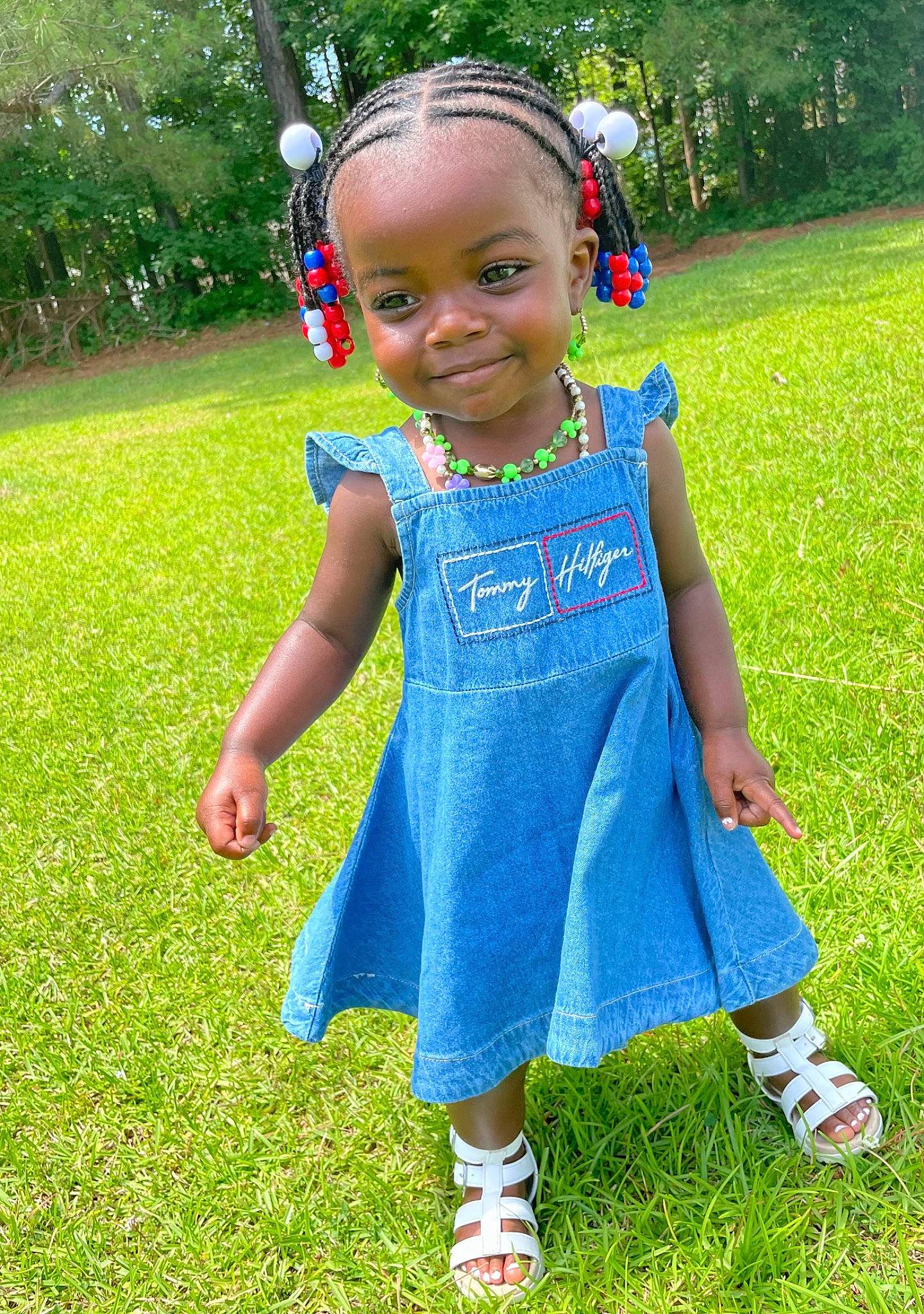 Jay'Leigh is registered to the contest to win money with this photo: baby_toddler_clothing, botany, child, day_dress, electric_blue, eye, face, footwear, fun, grass, green, happy, joy, leisure, one_piece_garment, people_in_nature, person, plant, sleeve, smile