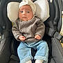 baby, black, blue, car_seat, child, clothing, comfort, cushion, cute, face, headwrap, indoor, infant, jeans, person, portrait, socks, sweater, toy, white