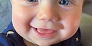 Frankie is registered to the contest to win money with this photo: baby, child, smiling, face, blue_eyes, cute, infant, close_up, clothing, stars_pattern, zipper, happy, portrait, skin, eyelashes, hand, indoors, soft_toy, cozy, warm