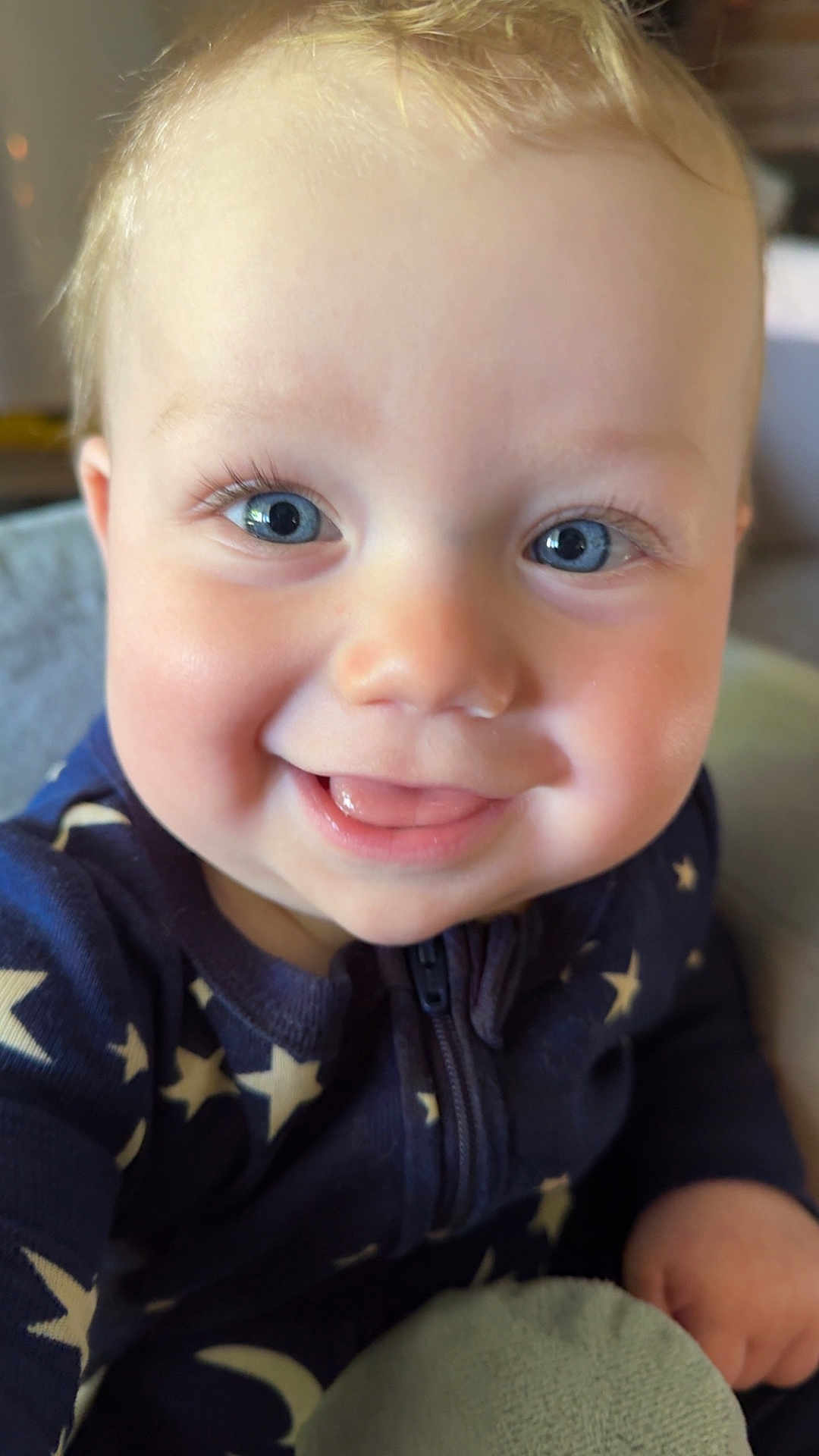 Frankie is registered to the contest to win money with this photo: baby, child, smiling, face, blue_eyes, cute, infant, close_up, clothing, stars_pattern, zipper, happy, portrait, skin, eyelashes, hand, indoors, soft_toy, cozy, warm