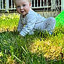 baby, child, grass, outdoor, crawling, pajamas, blue_eyes, curly_hair, porch, railing, sunlight, nature, person, infant, smiling, greenery, daylight, cute, young, playful