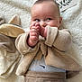 baby, beige, blanket, child, clothing, cute, face, hands, indoors, infant, knitwear, lying_down, milestone_card, newborn, playful, plush_toy, portrait, pose, smile, soft_texture