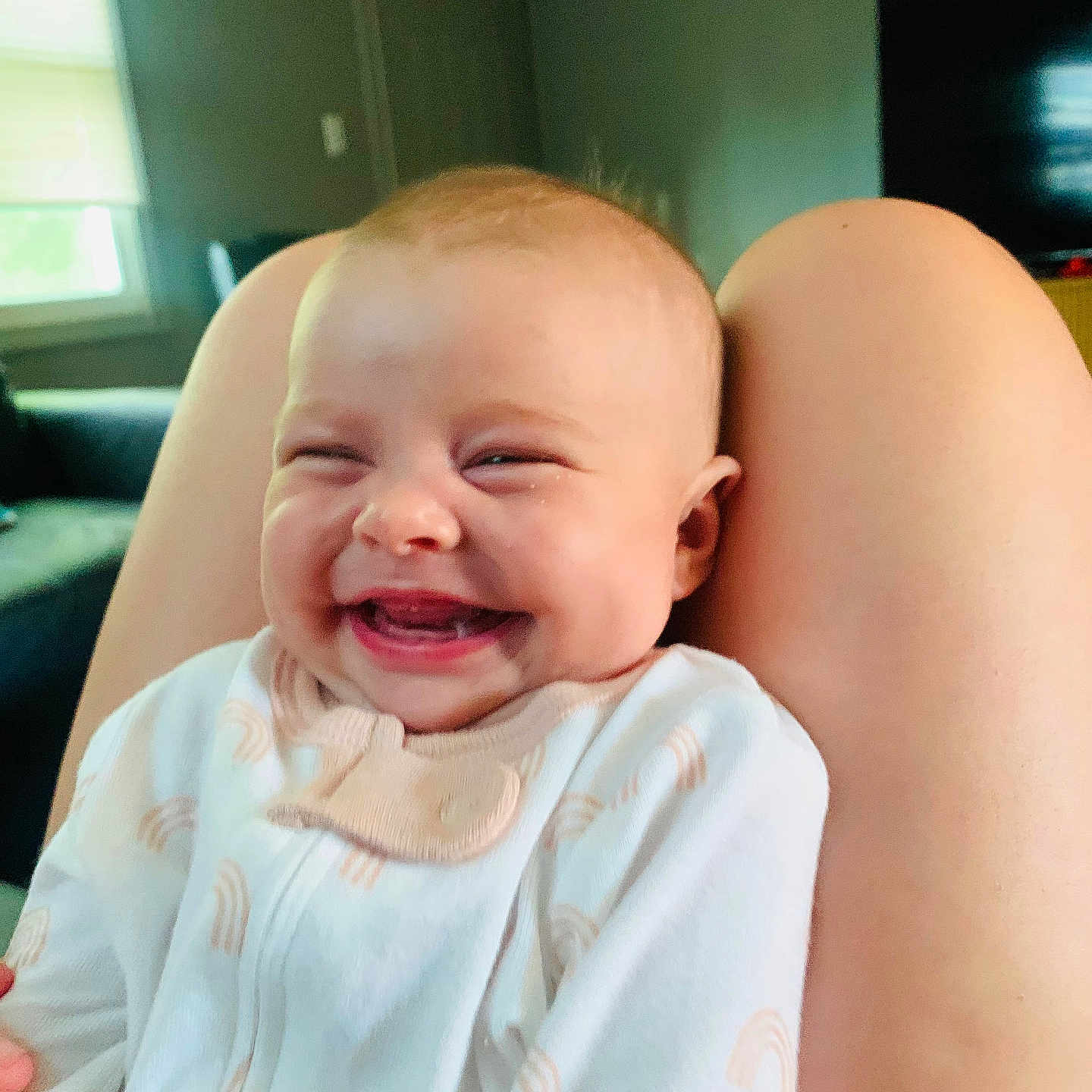 Willow is registered to the contest to win money with this photo: baby, child, clothing, comfort, cute, expression, face, happy, home, indoor, infant, joyful, legs, light, onesie, person, portrait, skin, smiling, window