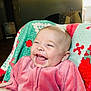 Willow joined the competition — help win amazing prizes! baby, smile, laughing, pink_clothing, blanket, red, green, indoor, person, child, happy, cozy, cute, infant, joy, face, head, hand, warm, casual