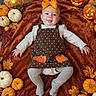 Jaceyn is registered to the contest to win money with this photo: baby, child, smiling, halloween, pumpkin, jack_o_lantern, autumn, leaves, orange_bow, costume, polka_dot, brown_blanket, portrait, indoor, festive, ghost_decoration, bat_decoration, fall, infant, seasonal_decor