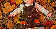 Jaceyn joined the competition — help win amazing prizes! baby, child, infant, halloween, autumn, fall, pumpkins, gourds, leaves, plaid_blanket, costume, dress, orange_bow, smiling, lying_down, portrait, lantern, acorn_character, seasonal_decor, text_overlay