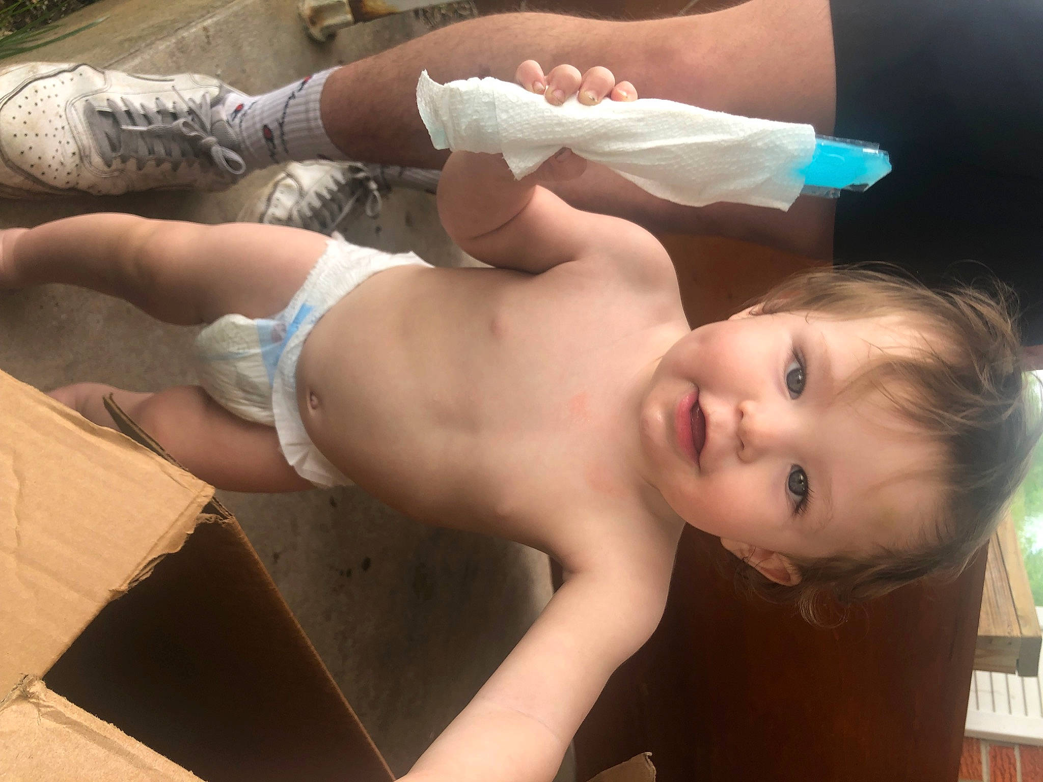 Theodore is registered to the contest to win money with this photo: abdomen, barechested, chest, elbow, finger, fun, happy, human_body, human_leg, joint, leg, lip, mouth, muscle, person, shipping_box, skin, smile, thigh, toddler