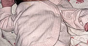 Nyloni Lashia is registered to the contest to win money with this photo: newborn, baby, infant, child, lying_down, sleeping, face, portrait, diaper, onesie, blanket, bed, baby_toy, pink, clothing, indoor, nursery, hand, curly_hair, close_up