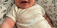 Xaidynn is registered to the contest to win money with this photo: arm, baby, baby_boy, baby_girl, child, chubby_cheeks, cushion, cute, face, happy, indoors, infant, laying_down, leaf_pattern, person, portrait, skin, smile, soft_lighting, white_onesie