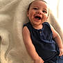 Xaidynn is registered to the contest to win money with this photo: baby, blanket, blue_clothing, casual, child, comfort, cute, face, hands, happy, indoors, infant, one_person, portrait, relaxing, sitting, skin, smiling, soft_texture, young_child