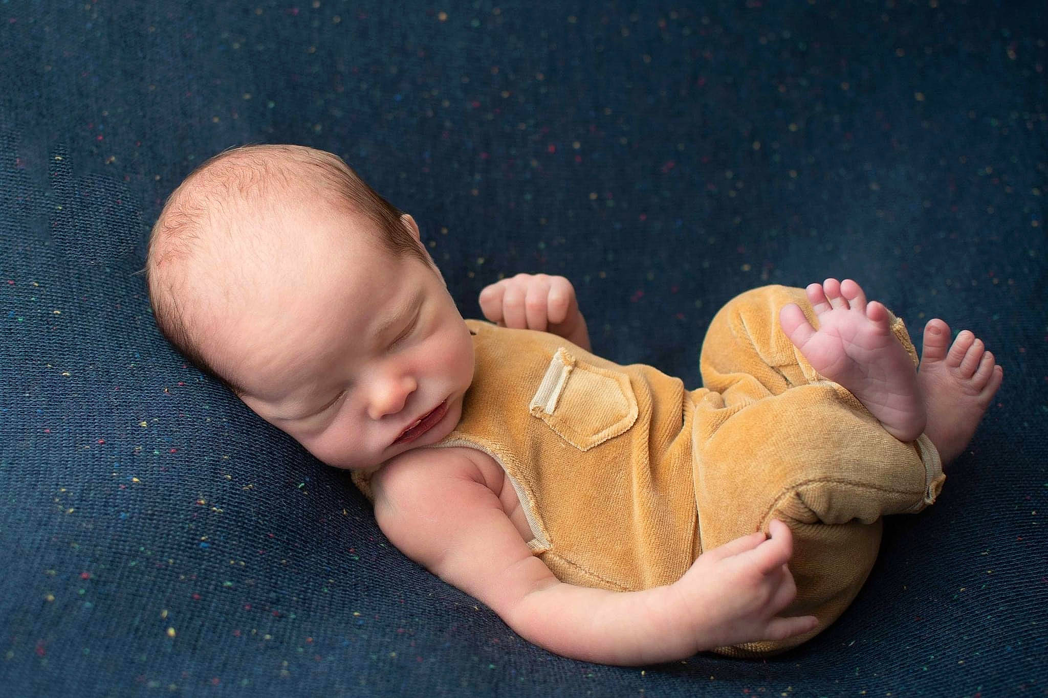 Weston is registered to the contest to win money with this photo: baby, baby_sleeping, baby_toddler_clothing, cheek, child, comfort, eye, finger, flash_photography, foot, gesture, grass, head, nose, person, sitting, skin, sleeve, thumb, toddler