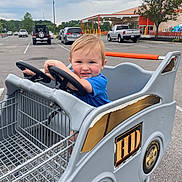 Raymond is registered to the contest to win money with this photo: baby, car, city, face, head, machine, outdoors, person, photography, pickuptruck, portrait, road, shoppingcart, spoke, street, transportation, truck, urban, vehicle, wheel