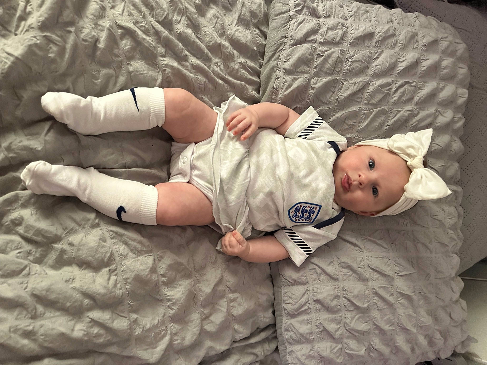 Isla joined the competition — help win amazing prizes! baby, baby_toddler_clothing, beauty, child, comfort, elbow, foot, gesture, head, headwear, human, human_leg, linens, pattern, person, sitting, sleeve, textile, thigh, toddler