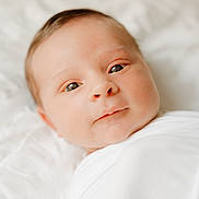 Joshua is registered to the contest to win money with this photo: baby, infant, face, portrait, newborn, wrapped, blanket, white, skin, cute, eyes, young, child, soft_light, peaceful, lying_down, indoors, close_up, sleepwear, swaddled