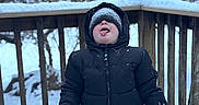 Dallas is registered to the contest to win money with this photo: child, cold, frost, fun, happy, hat, jacket, jeans, mittens, nature, outdoor, person, playful, seasonal, snow, snow_covered, tongue, trees, winter, wooden_railing