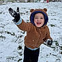Dallas is registered to the contest to win money with this photo: child, toddler, snow, winter, outdoor, hoodie, brown, gloves, playful, smiling, happy, grass, doghouse, yard, cold, fun, clothing, person, snowball, nature